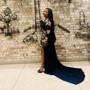 A really cute navy blue prom dress with floor length train in good condition